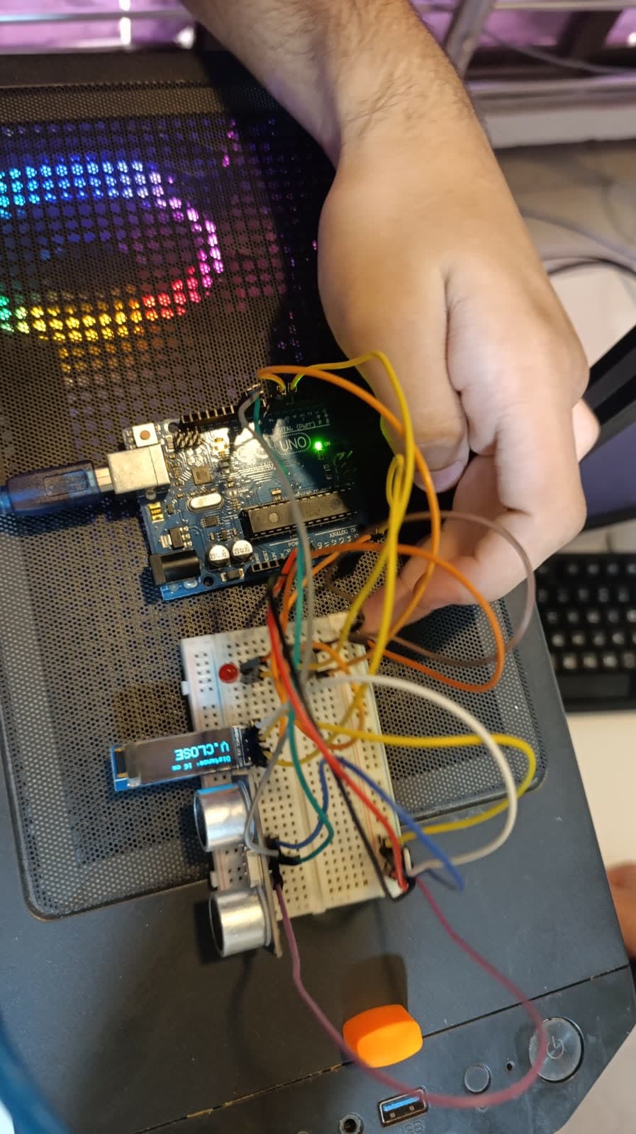 An instructor working through the wiring of a distance sensor with a student